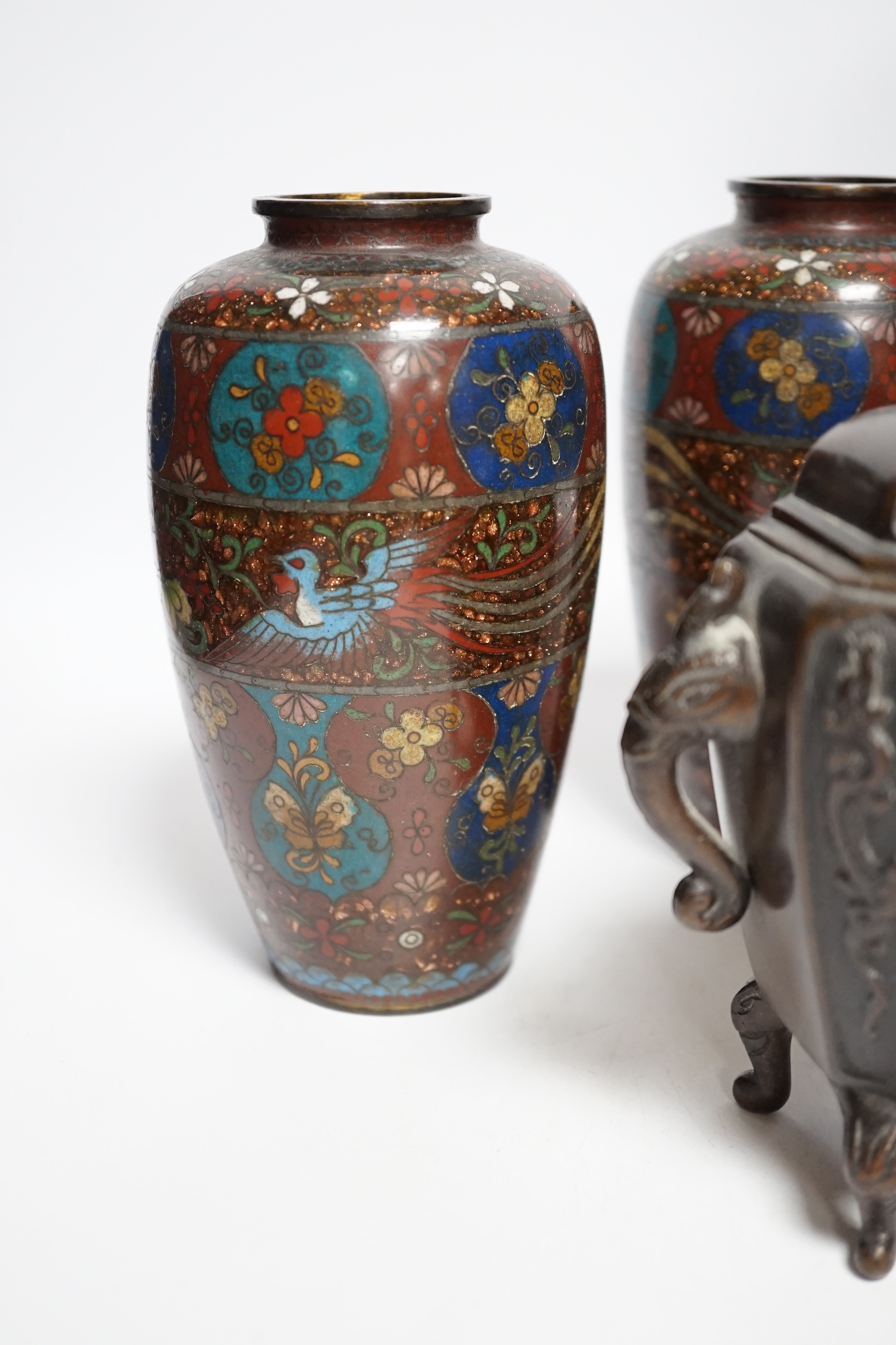 A Meiji period Japanese bronze jardiniere, a pair of cloisonné vases, a hardwood stand, etc.